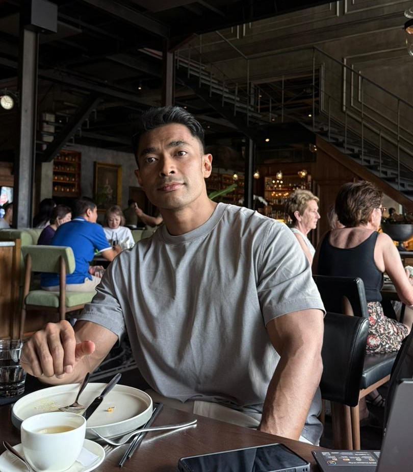Riz from Built By Riz seated at a cafe table