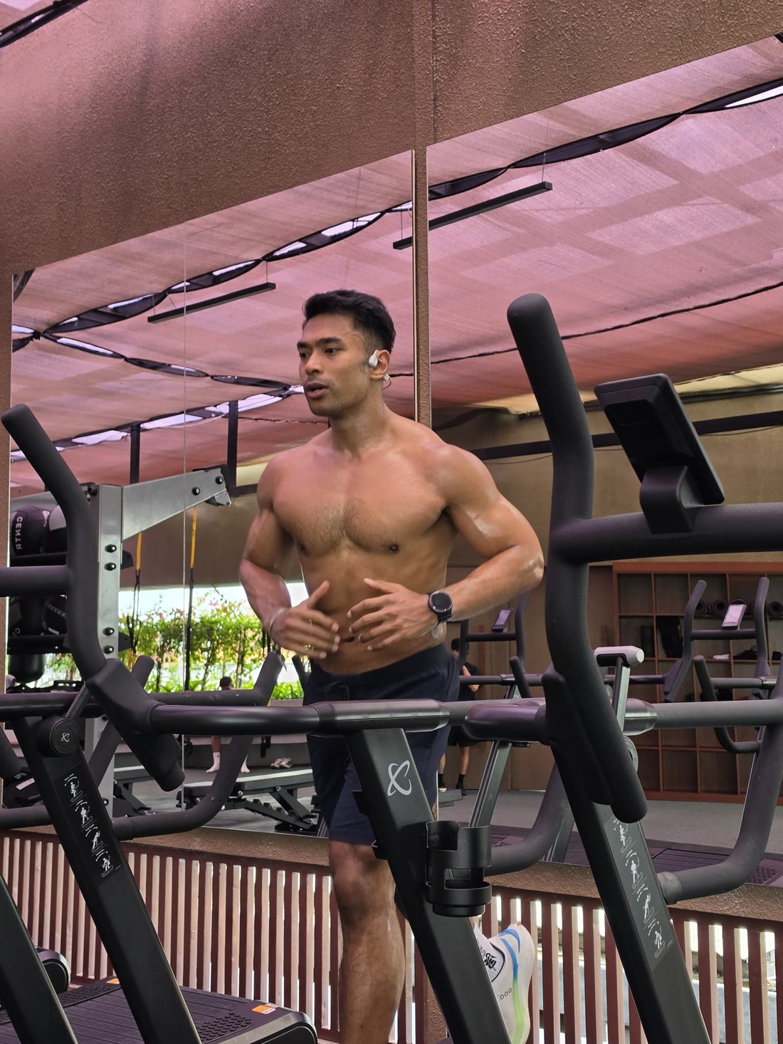 Riz training on cardio equipment in a gym